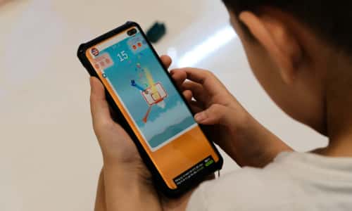 A child playing an interactive game on a phone